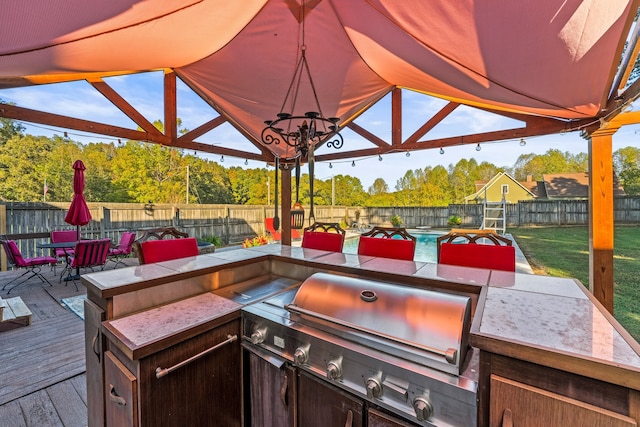 view of patio / terrace featuring a gazebo, a wooden deck, and grilling area