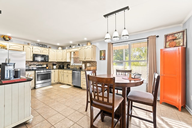 kitchen with light tile patterned flooring, crown molding, stainless steel appliances, and pendant lighting