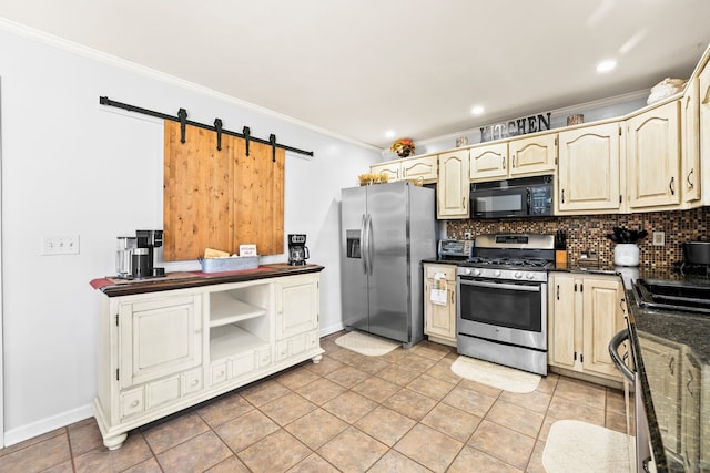 kitchen with backsplash, appliances with stainless steel finishes, a barn door, light tile patterned flooring, and crown molding