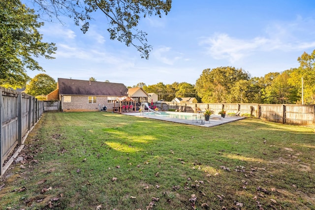 view of yard with a patio and a fenced in pool