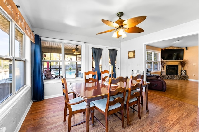 dining area with hardwood / wood-style floors, a healthy amount of sunlight, and ceiling fan