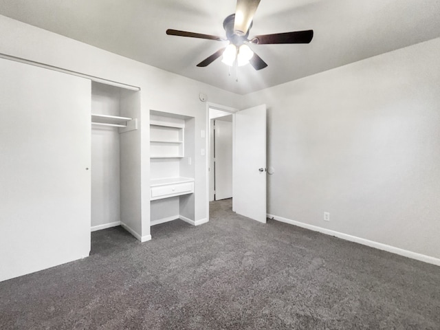 unfurnished bedroom featuring dark colored carpet, a closet, and ceiling fan