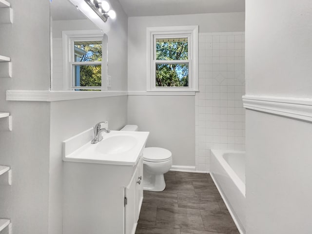 bathroom with vanity, tile patterned floors, toilet, and plenty of natural light