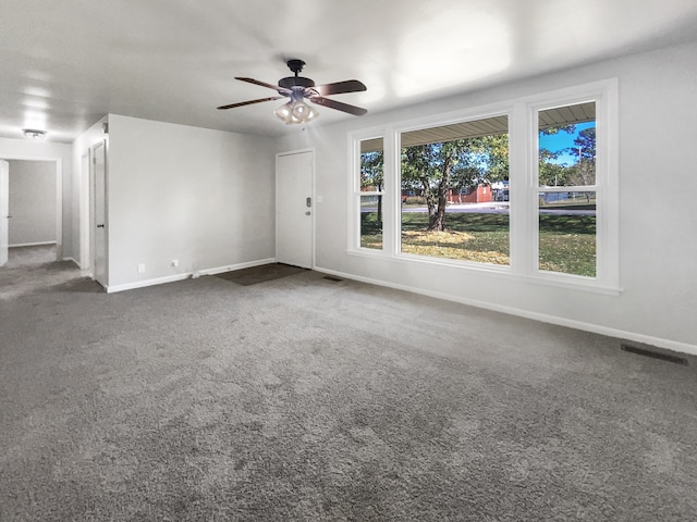 carpeted empty room featuring ceiling fan