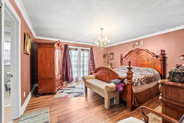 bedroom with a notable chandelier, ornamental molding, a textured ceiling, and light wood-type flooring