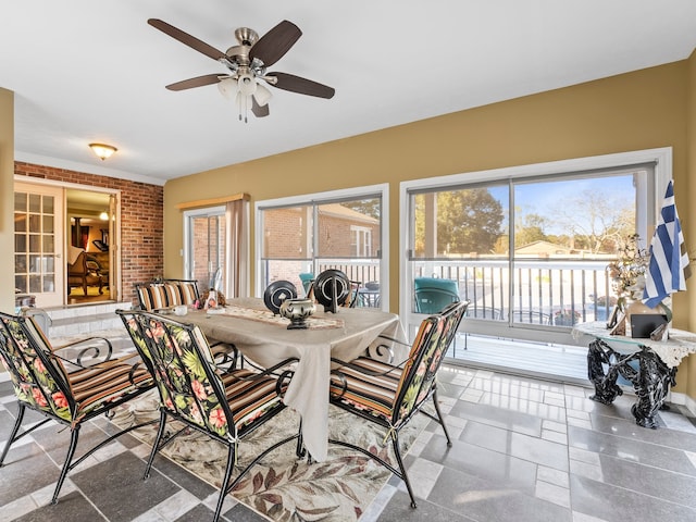 sunroom / solarium featuring ceiling fan