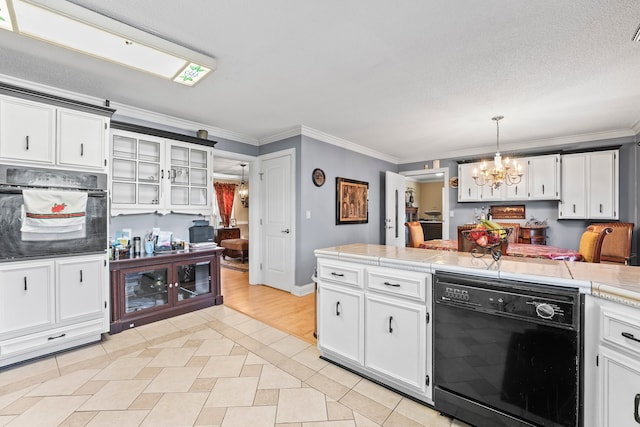 kitchen with white cabinets, ornamental molding, black appliances, a notable chandelier, and decorative light fixtures