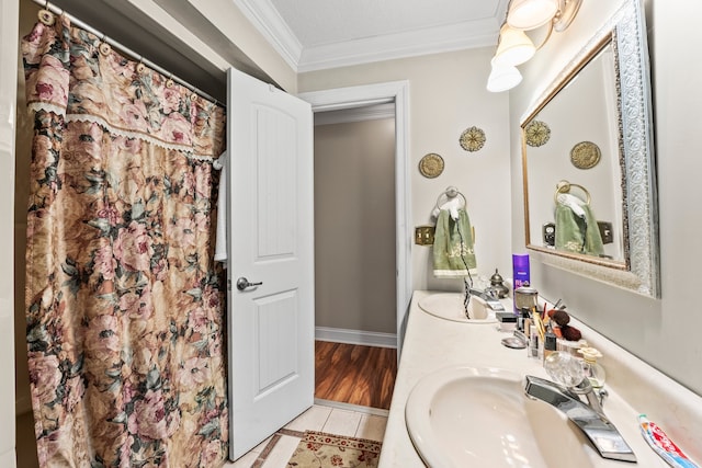 bathroom featuring vanity, tile patterned floors, crown molding, and a textured ceiling