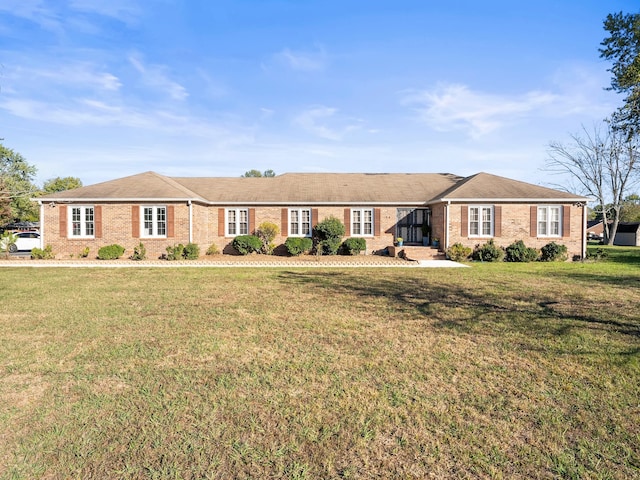 ranch-style home with a front lawn