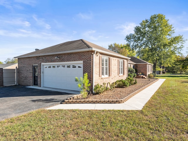 view of property exterior featuring a lawn and a garage