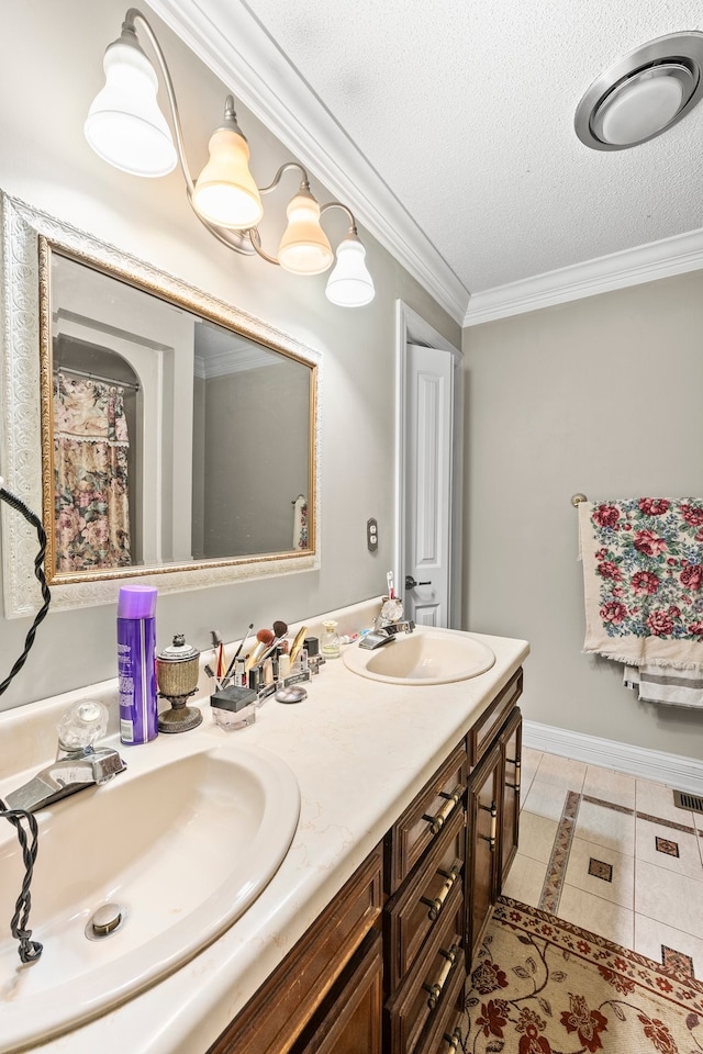 bathroom featuring vanity, a textured ceiling, ornamental molding, and tile patterned flooring