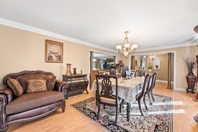 dining room with light hardwood / wood-style flooring, a chandelier, and crown molding