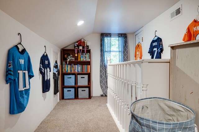 hallway with lofted ceiling and carpet