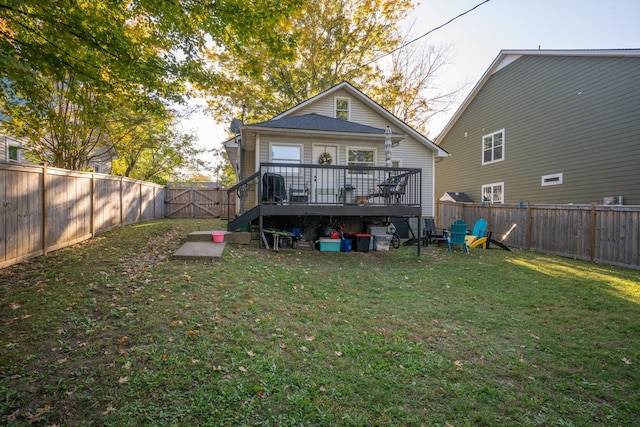 back of house with a wooden deck and a lawn