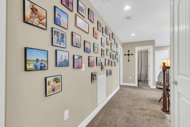 corridor featuring light colored carpet