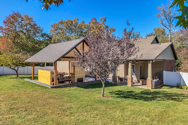 rear view of house with a yard, a patio area, and an outdoor hangout area