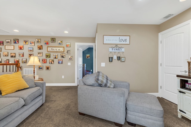 living room with dark colored carpet