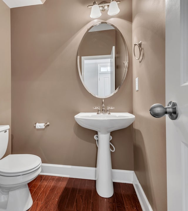 bathroom featuring toilet and hardwood / wood-style flooring