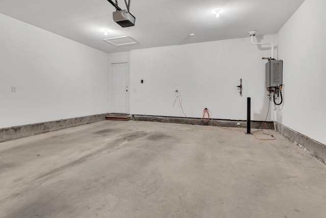 garage featuring a garage door opener and tankless water heater