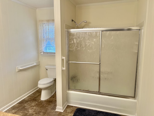 bathroom featuring bath / shower combo with glass door, a textured ceiling, toilet, crown molding, and wooden walls