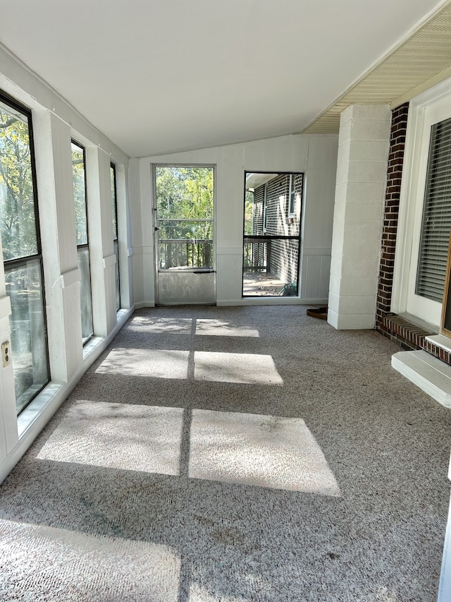 unfurnished sunroom with lofted ceiling