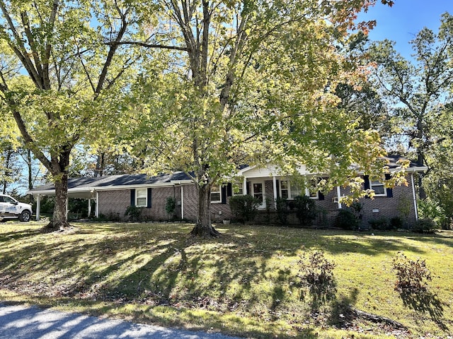 obstructed view of property with a front yard