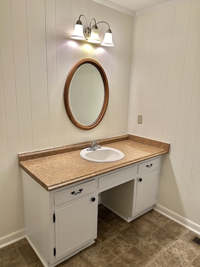 bathroom with vanity and wooden walls