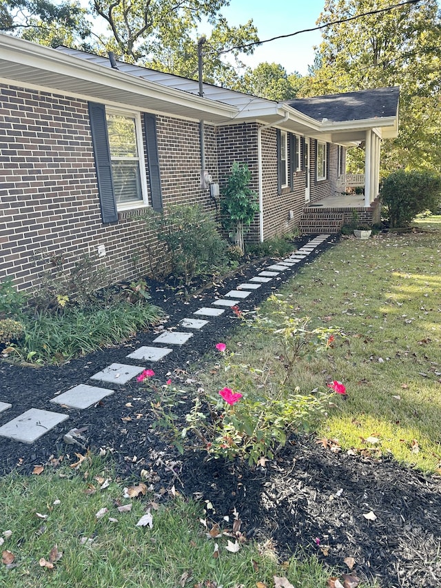 view of side of property with a lawn