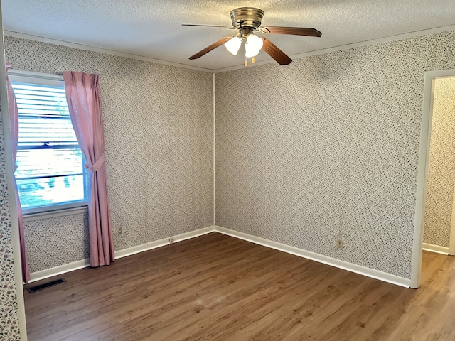 unfurnished room featuring hardwood / wood-style floors, a textured ceiling, and ceiling fan