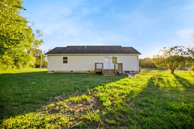 back of property with a lawn