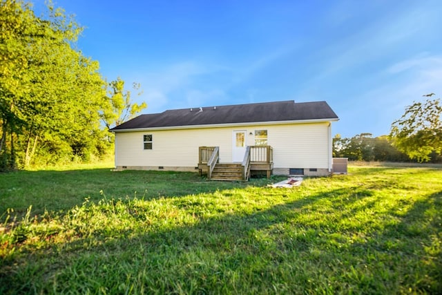 rear view of property with central air condition unit and a lawn