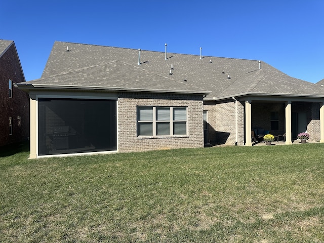 rear view of property featuring a yard