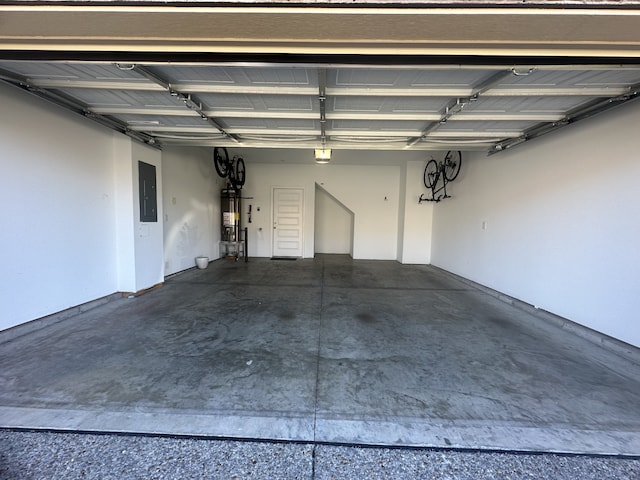 garage with electric panel and strapped water heater