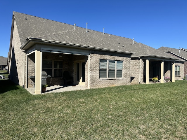 rear view of property with a lawn and exterior kitchen