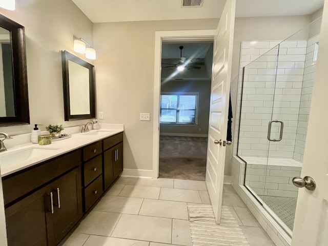 bathroom featuring tile patterned flooring, vanity, ceiling fan, and walk in shower