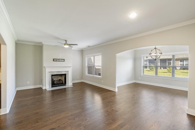 1509 Cedarbrooke Ln, Lebanon, TN 37090 - unfurnished living room featuring arched walkways, a ceiling fan, plenty of natural light, a chandelier, and ornamental molding