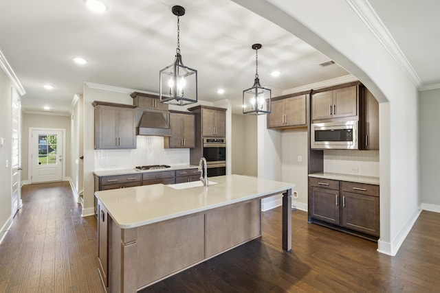 1509 Cedarbrooke Ln, Lebanon, TN 37090 - kitchen with appliances with stainless steel finishes, backsplash, a kitchen island with sink, custom exhaust hood, and dark wood-style flooring