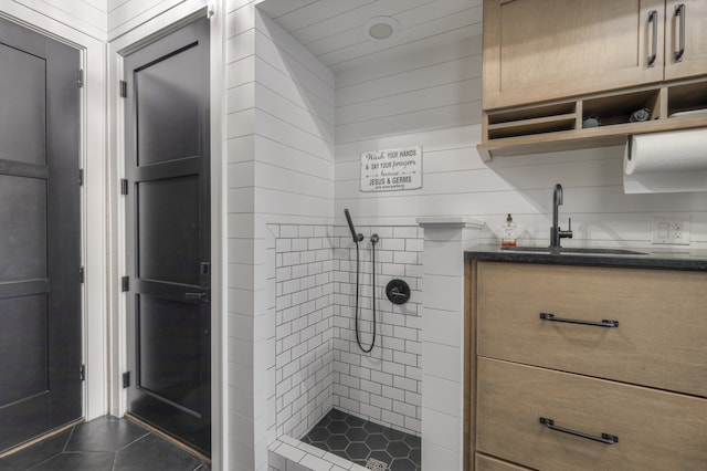 bathroom with vanity, tile patterned floors, and tiled shower