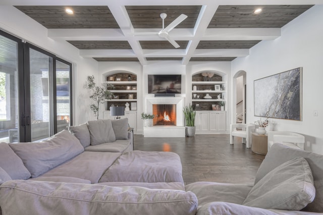 living room featuring french doors, built in features, coffered ceiling, beamed ceiling, and hardwood / wood-style flooring