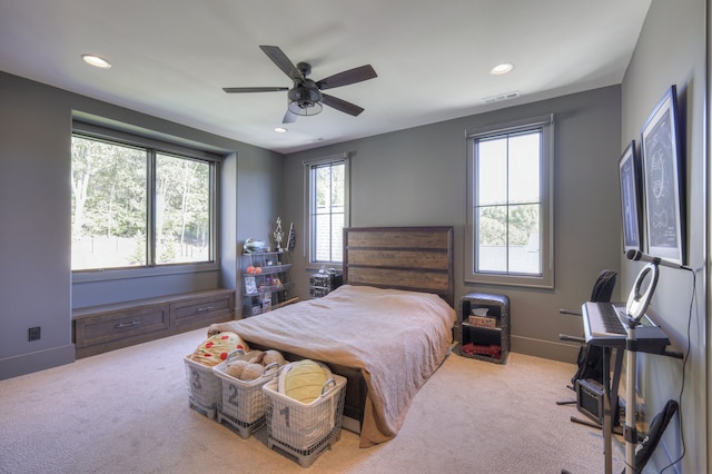 bedroom featuring light carpet and ceiling fan