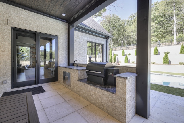 view of patio featuring an outdoor kitchen, sink, and grilling area