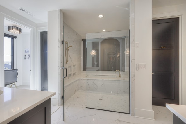 bathroom with vanity and shower with separate bathtub