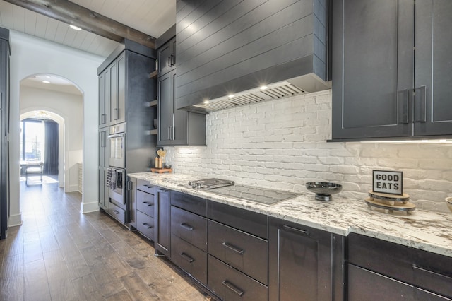 kitchen featuring beam ceiling, premium range hood, light stone countertops, and dark hardwood / wood-style flooring