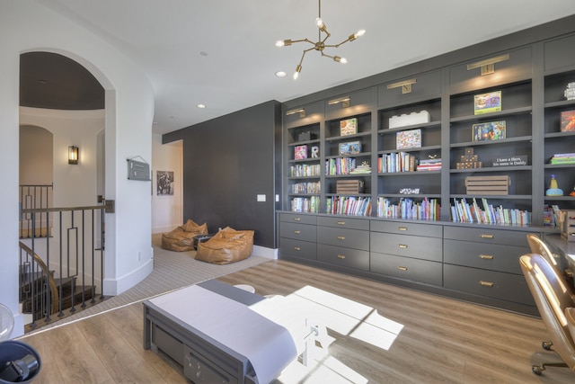 interior space with light hardwood / wood-style floors and an inviting chandelier