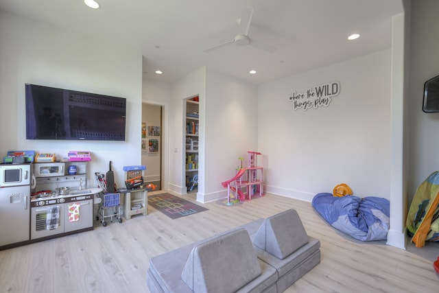 game room with light hardwood / wood-style floors and ceiling fan