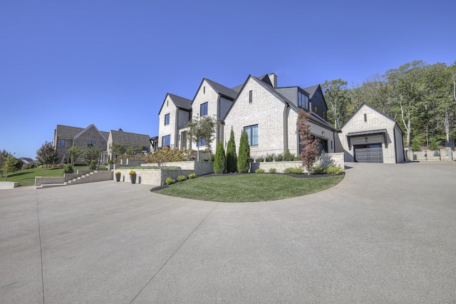 view of front of home with a front lawn and a garage