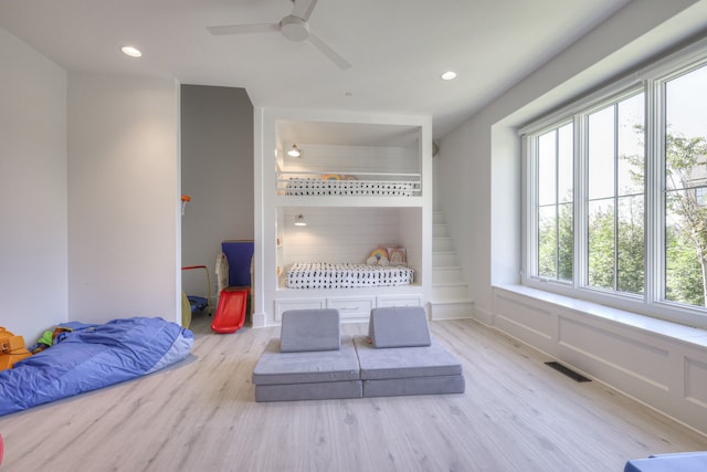 living area featuring ceiling fan and light hardwood / wood-style flooring