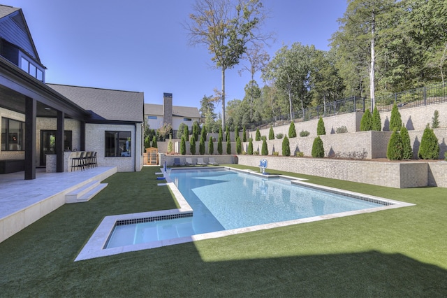 view of pool with a patio and a lawn