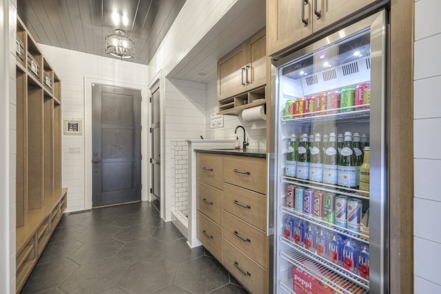 interior space featuring wet bar and dark tile patterned flooring