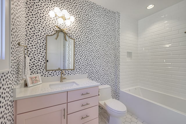 full bathroom featuring toilet, tile walls, tiled shower / bath, vanity, and tile patterned flooring